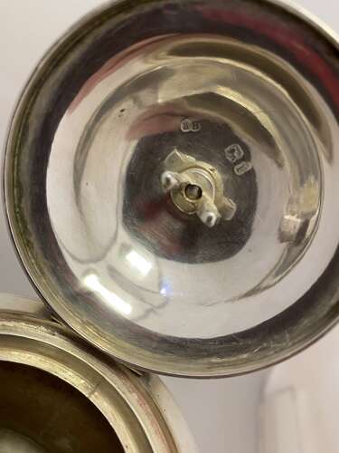 A silver pear shaped coffee pot.