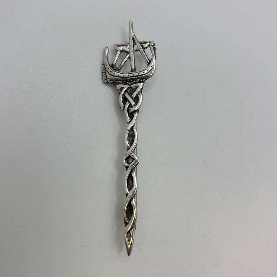 Silver kilt pin with ship and celtic design.