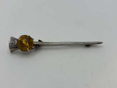 Silver kilt pin in thistle form.