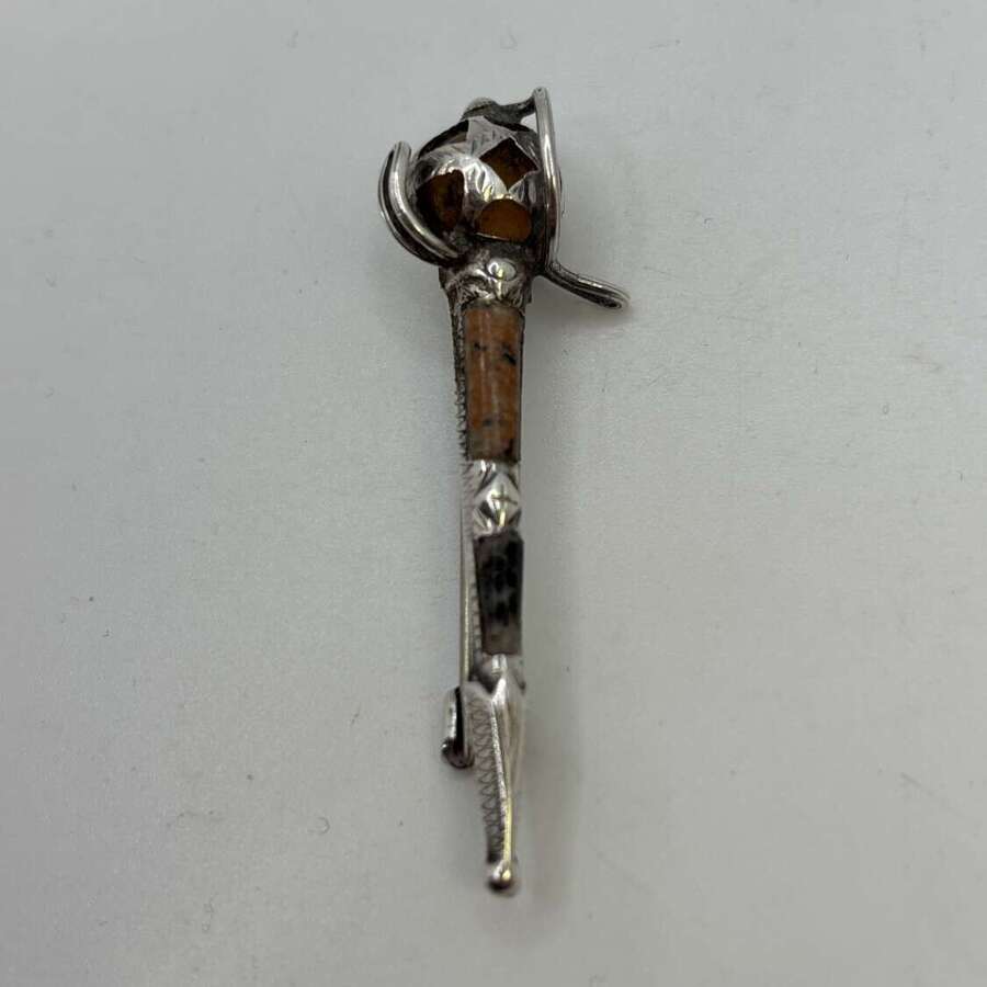 Silver and agate pin in basket hilted sword form.