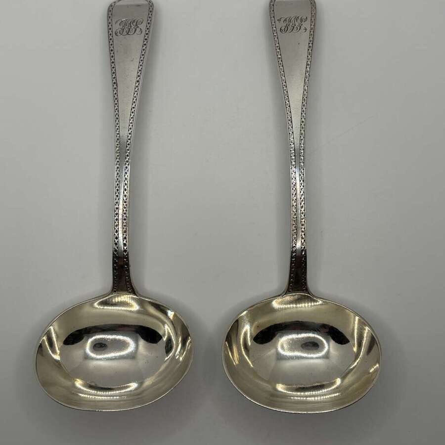 Pair of silver sauce ladles, London 1868.