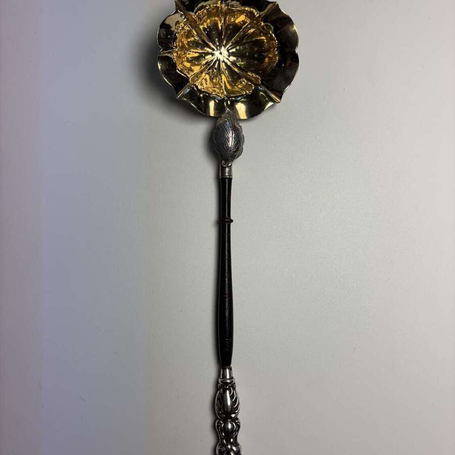 Georgian silver gilt tea strainer with handle, circa 1795.